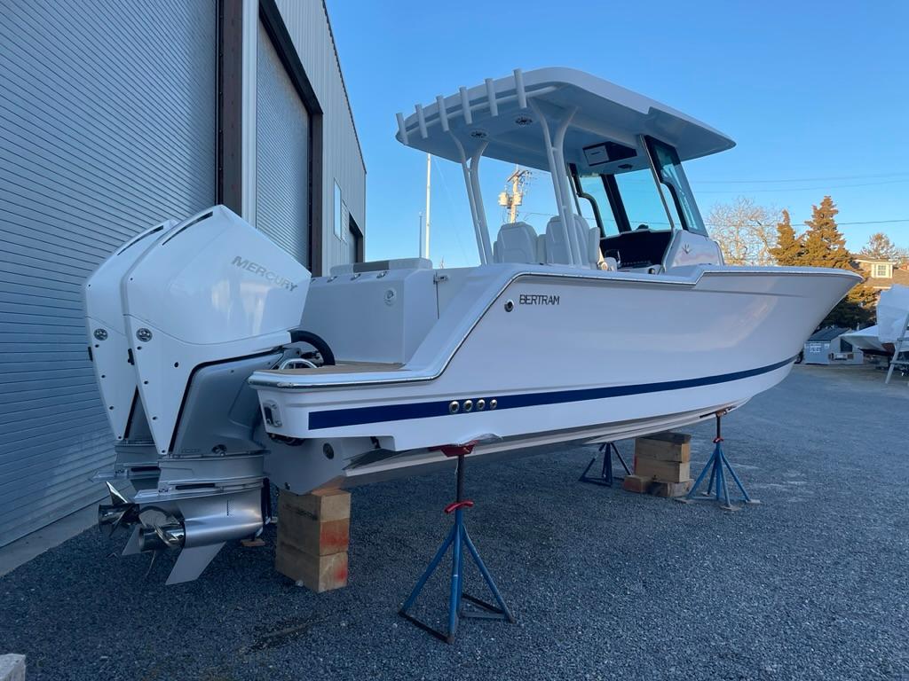 2023 Bertram 28 CC boat on stands outside a warehouse.