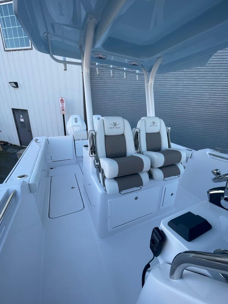 2023 Bertram 28 CC boat interior with dual captain's chairs and modern controls.