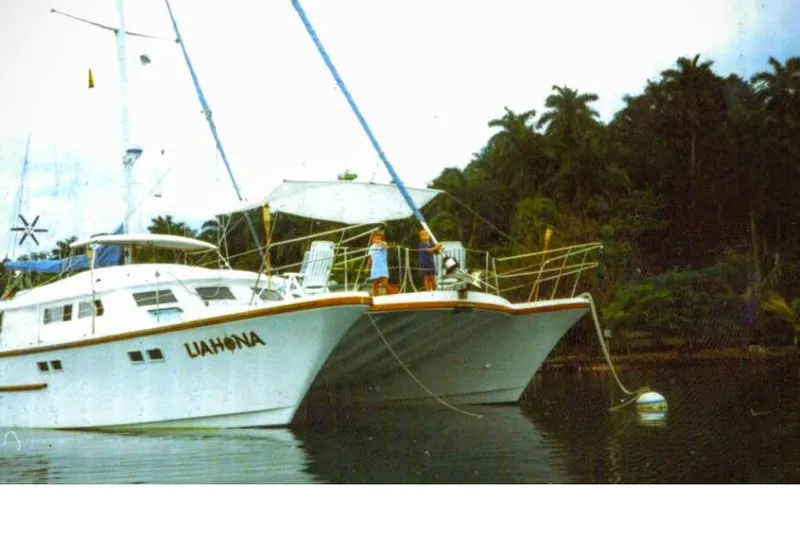 Liahona Yacht Photos Pics Custom 1985 model 60 yacht "Liahona" anchored near lush tropical shoreline.
