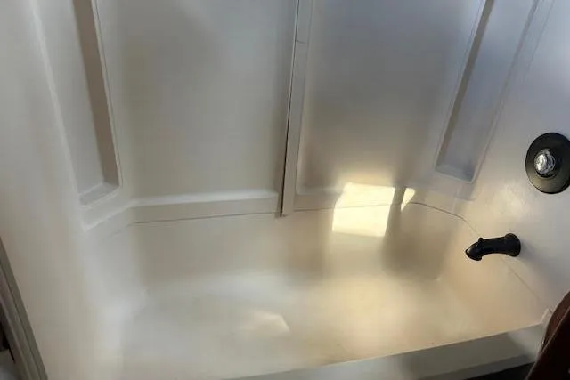 Liahona Yacht Photos Pics White bathtub with built-in shelves, Custom model 60, 1985 design.