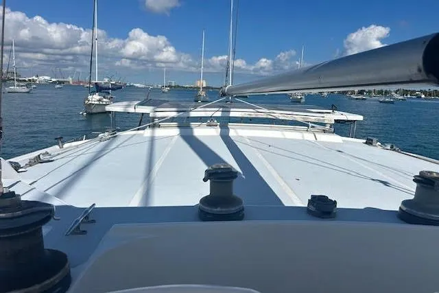 Liahona Yacht Photos Pics Bow view of a 1985 Custom 60 yacht in a marina with clear skies.