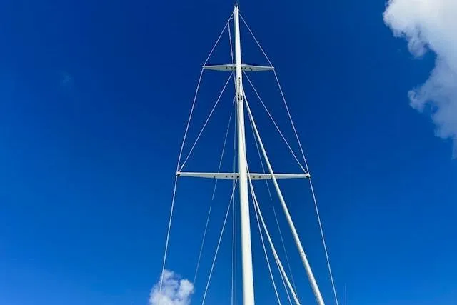 Liahona Yacht Photos Pics Tall sailboat mast against clear blue sky, Custom 60 model, 1985.