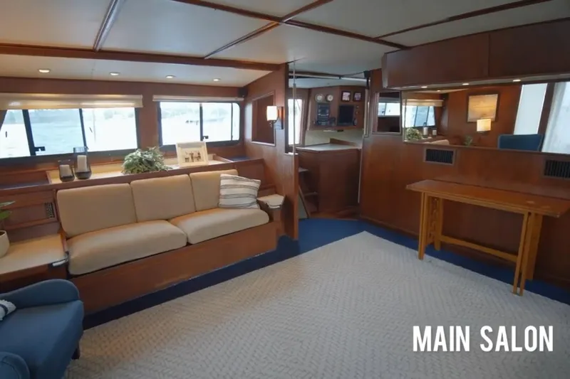 Liahona Yacht Photos Pics Main salon of 1985 Custom 60 yacht with elegant wood interior and cozy seating.