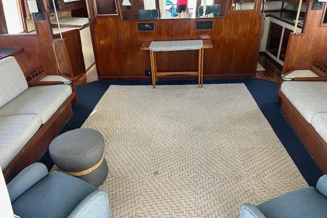 Liahona Yacht Photos Pics Interior of a 1985 Custom 60 yacht with cozy seating and wooden accents.
