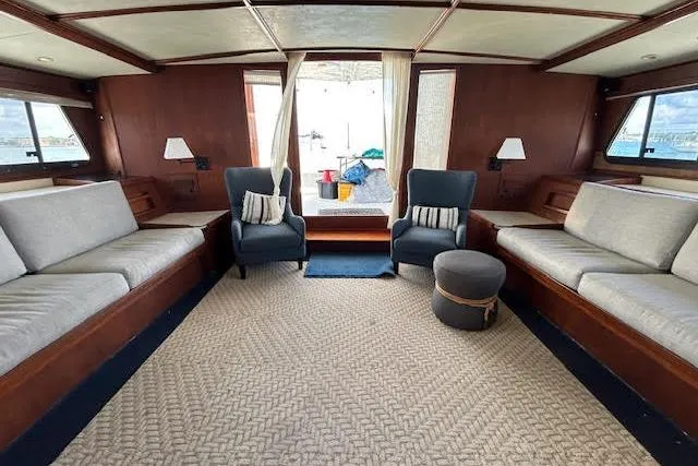 Liahona Yacht Photos Pics Luxurious interior of a 1985 Custom 60 yacht with elegant seating and nautical decor.