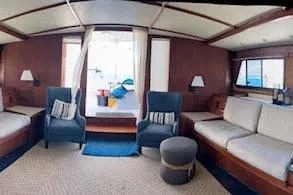Liahona Yacht Photos Pics Interior of a 1985 Custom 60 yacht with cozy seating and nautical decor.