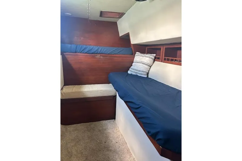 Liahona Yacht Photos Pics Cozy cabin interior of a 1985 Custom model 60 boat with blue bedding.