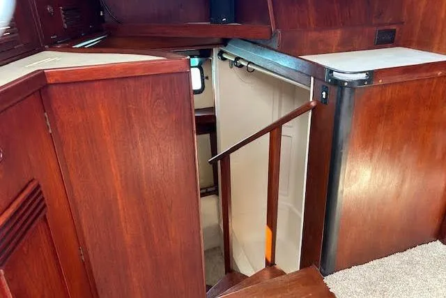Liahona Yacht Photos Pics Interior of a 1985 Custom 60 yacht with wooden cabinetry and stairs.