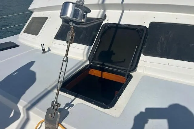 Liahona Yacht Photos Pics Open hatch on 1985 Custom 60 sailboat deck with visible winch and shadows.