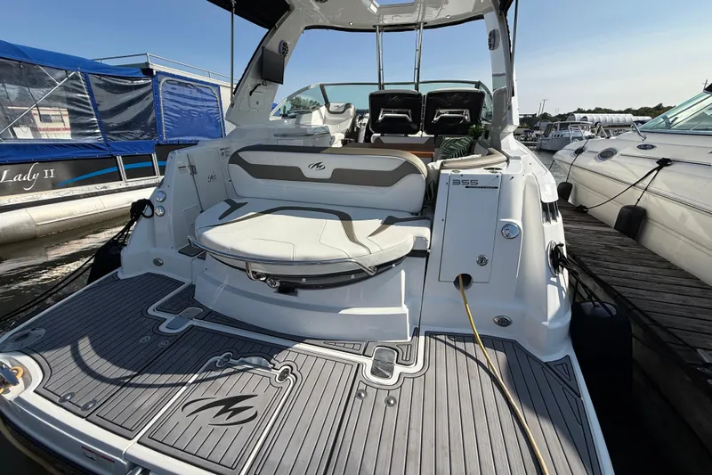  Yacht Photos Pics 2018 Monterey 355 Sport Yacht docked, showcasing spacious deck and seating area.