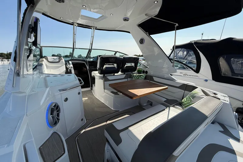  Yacht Photos Pics 2018 Monterey 355 Sport Yacht interior with seating, table, and helm, docked at marina.