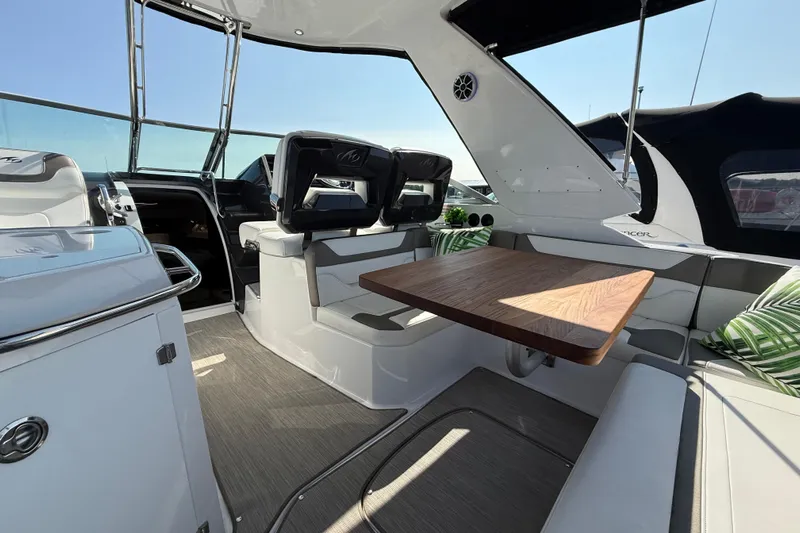  Yacht Photos Pics 2018 Monterey 355 Sport Yacht interior with seating and wooden table.