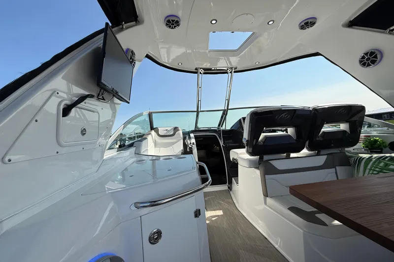  Yacht Photos Pics 2018 Monterey 355 Sport Yacht interior with seating, table, and mounted TV.