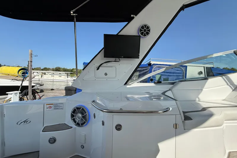  Yacht Photos Pics 2018 Monterey 355 Sport Yacht interior with TV and speaker, docked under clear blue sky.