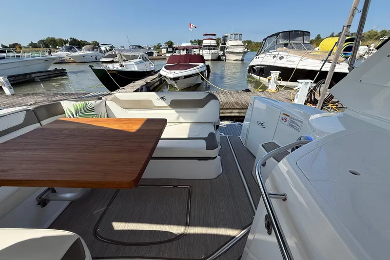  Yacht Photos Pics 2018 Monterey 355 Sport Yacht interior with wooden table, docked at marina.