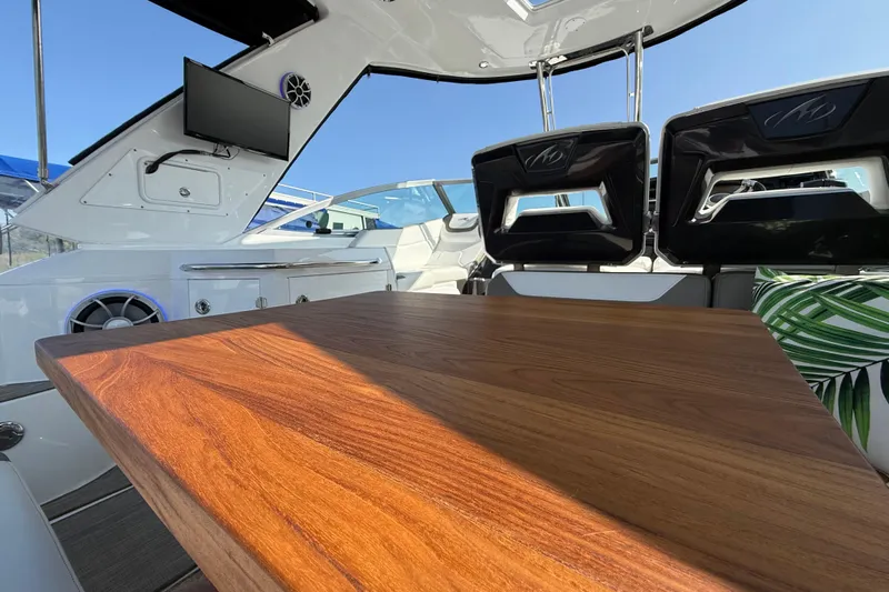  Yacht Photos Pics 2018 Monterey 355 Sport Yacht interior with wooden table, modern seating, and mounted TV.
