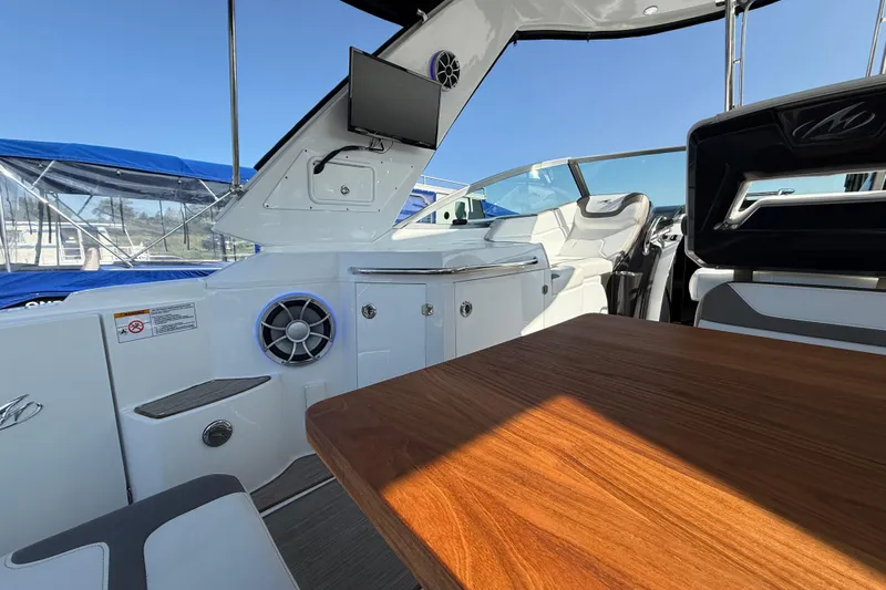  Yacht Photos Pics 2018 Monterey 355 Sport Yacht interior with wood table, seating, and entertainment system.