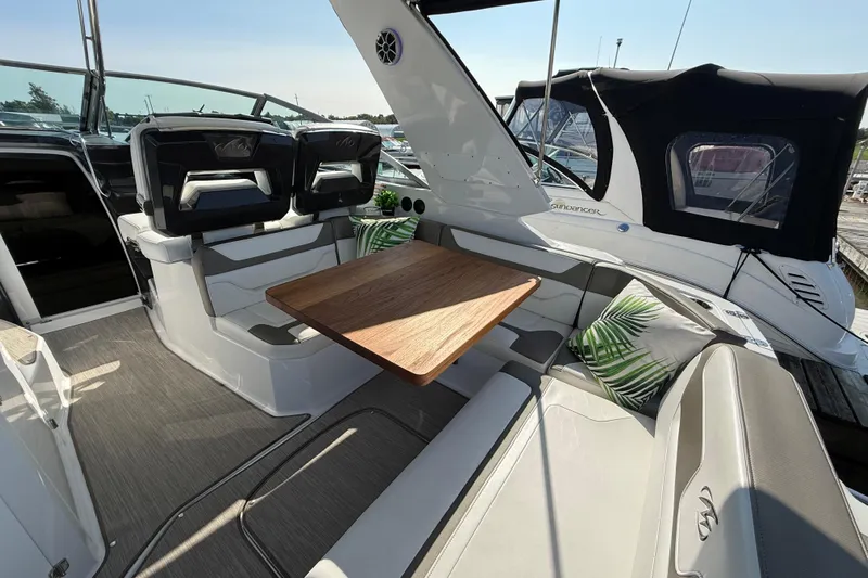  Yacht Photos Pics 2018 Monterey 355 Sport Yacht interior with seating, table, and cushions.
