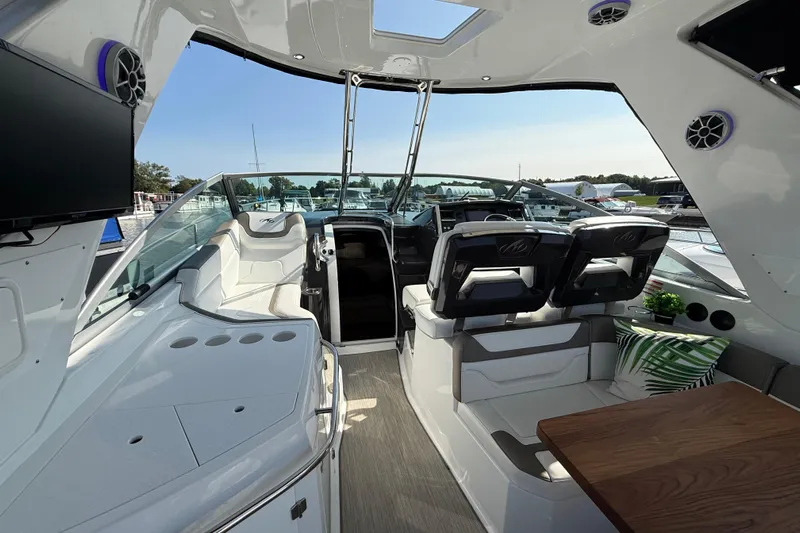  Yacht Photos Pics 2018 Monterey 355 Sport Yacht interior with seating, table, and helm, docked at marina.