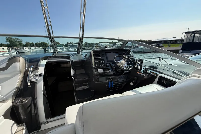  Yacht Photos Pics 2018 Monterey 355 Sport Yacht cockpit with modern controls and steering wheel, docked at marina.