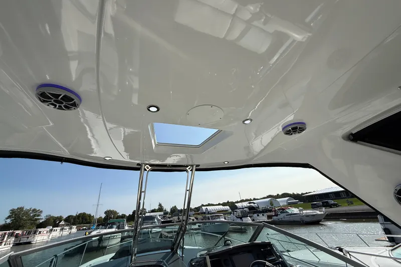  Yacht Photos Pics 2018 Monterey 355 Sport Yacht interior with speakers and skylight, docked at marina.