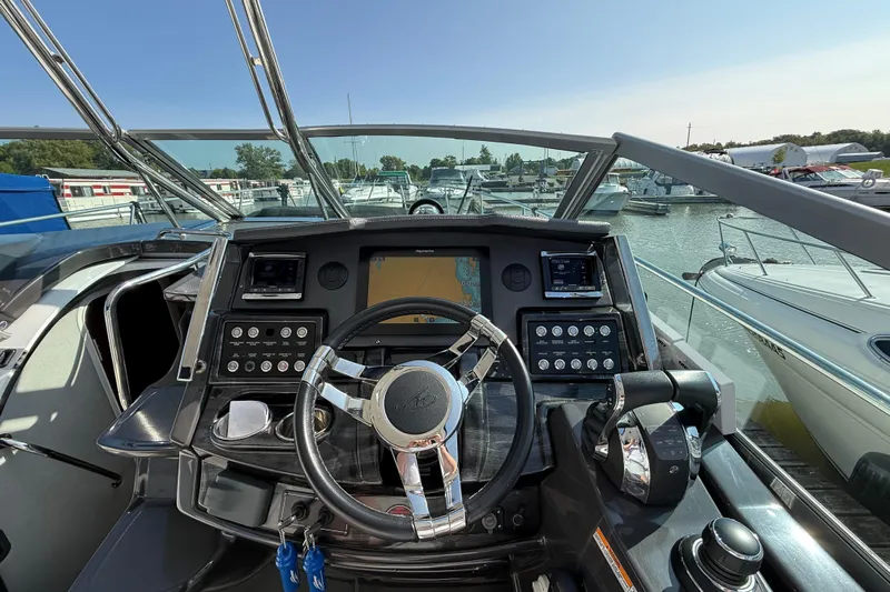  Yacht Photos Pics Cockpit view of 2018 Monterey 355 Sport Yacht with modern navigation controls.