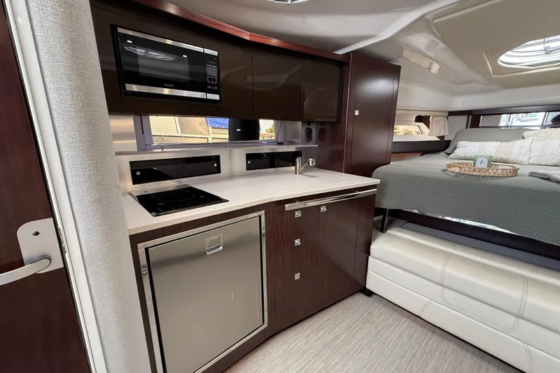  Yacht Photos Pics Interior of 2018 Monterey 355 Sport Yacht with modern kitchen and cozy sleeping area.
