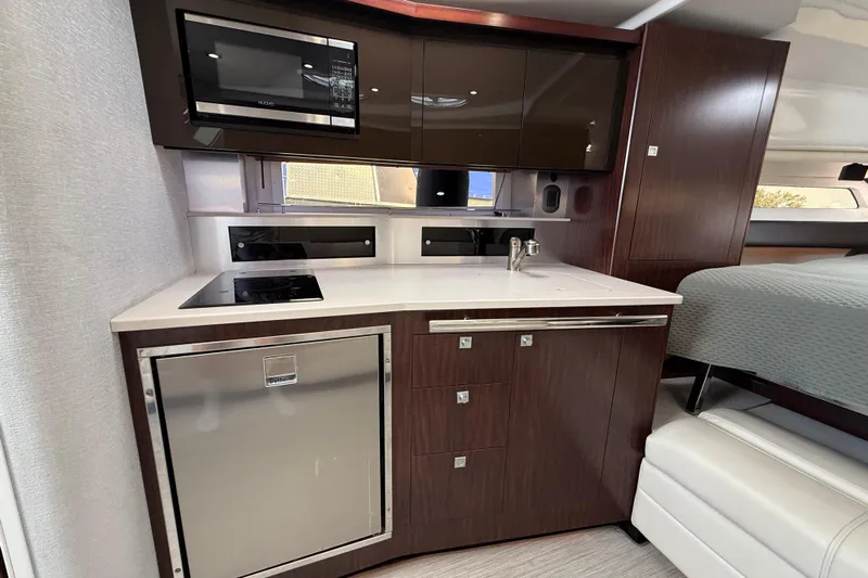  Yacht Photos Pics Modern kitchen area in 2018 Monterey 355 Sport Yacht with microwave and compact fridge.