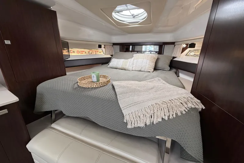  Yacht Photos Pics Luxurious cabin interior of 2018 Monterey 355 Sport Yacht with cozy bedding and elegant decor.