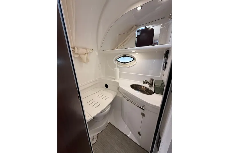  Yacht Photos Pics 2018 Monterey 355 Sport Yacht bathroom with sink, mirror, and porthole window.