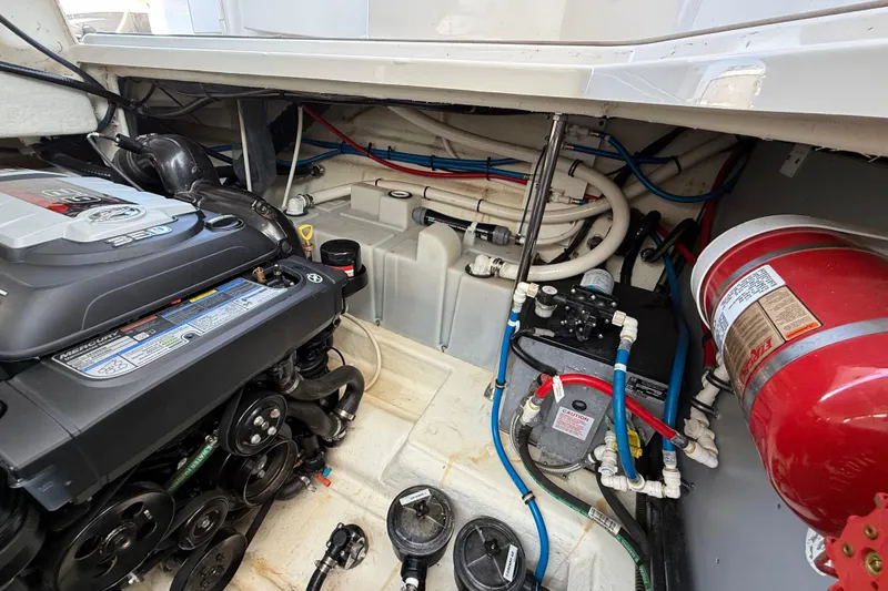  Yacht Photos Pics Engine compartment of a 2018 Monterey 355 Sport Yacht, showcasing mechanical components and fire extinguisher.