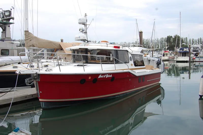 Yacht Photos Pics 2018 Ranger Tugs R29 boat docked in marina, featuring a striking red hull.