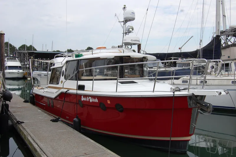  Yacht Photos Pics 2018 Ranger Tugs R29 boat docked in marina, featuring red hull and white cabin.