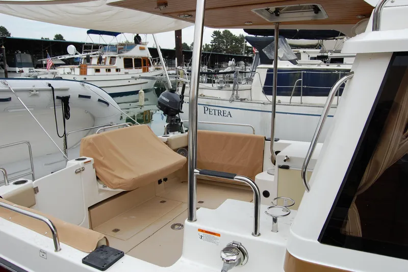 Yacht Photos Pics 2018 Ranger Tugs R29 boat interior at marina, featuring covered seating and docked vessels.