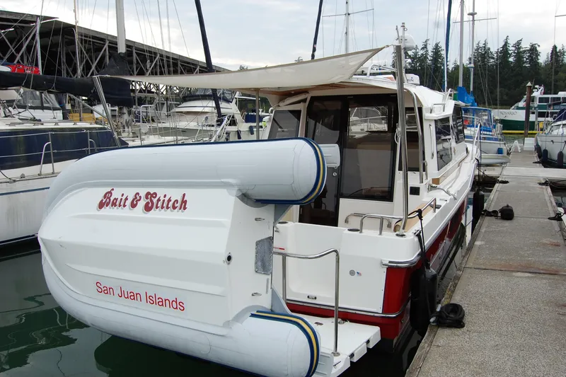  Yacht Photos Pics 2018 Ranger Tugs R29 docked at marina, featuring "Bait & Stitch" and San Juan Islands text.