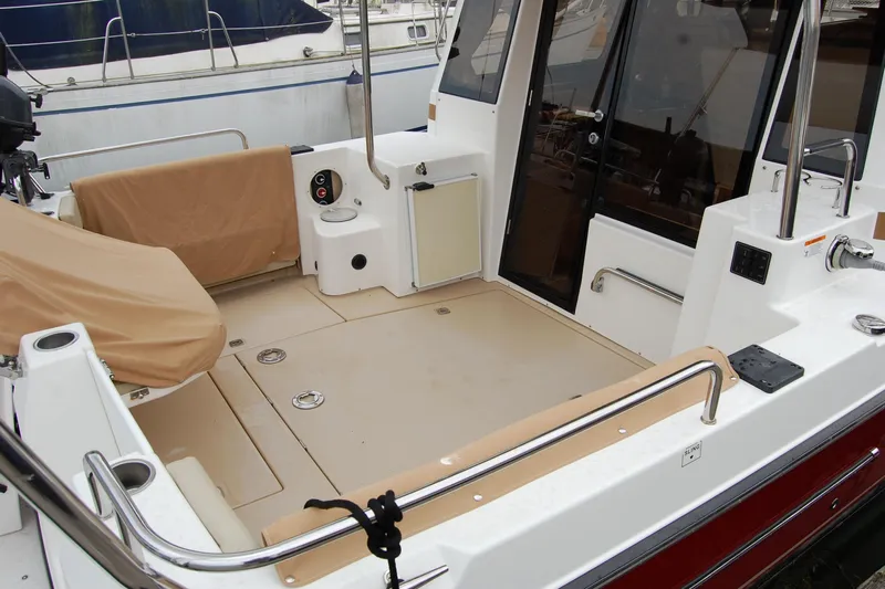  Yacht Photos Pics 2018 Ranger Tugs R29 boat deck with seating and railing in a marina.