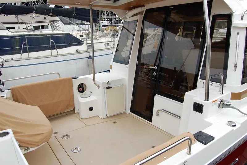  Yacht Photos Pics 2018 Ranger Tugs R29 boat deck with covered seating and glass doors.