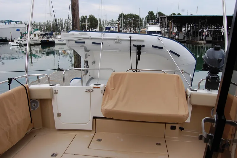 Yacht Photos Pics 2018 Ranger Tugs R29 boat interior with covered seating and docked view.