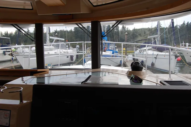  Yacht Photos Pics Interior view from 2018 Ranger Tugs R29, overlooking marina with docked sailboats.