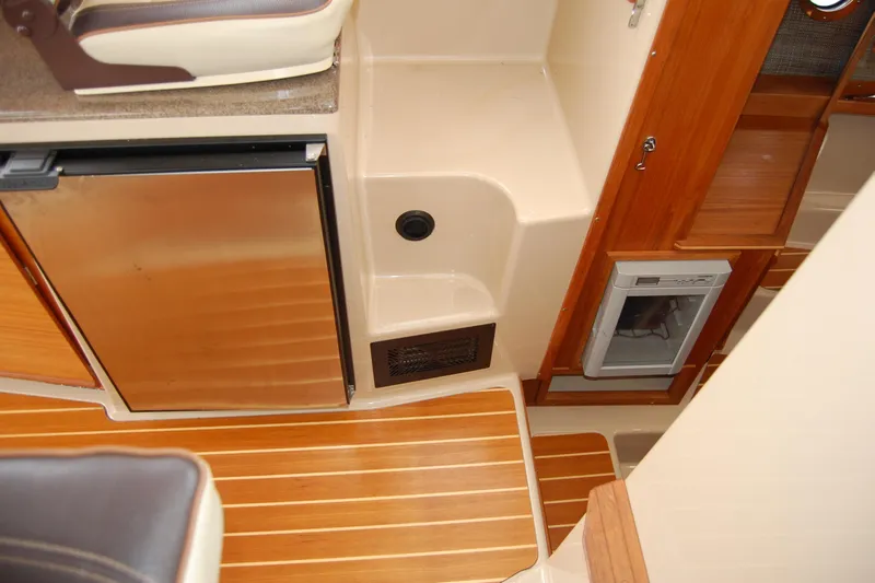  Yacht Photos Pics Interior of 2018 Ranger Tugs R29 with wood flooring and compact kitchen appliances.