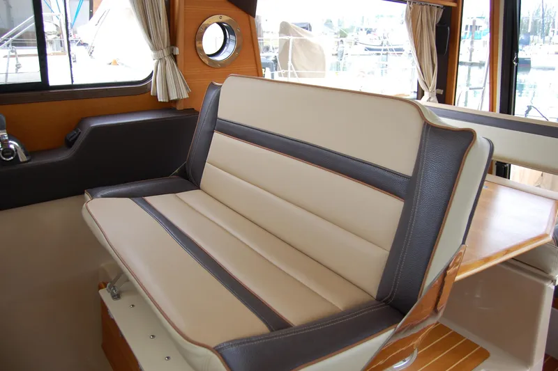  Yacht Photos Pics 2018 Ranger Tugs R29 interior seating with beige and brown upholstery.