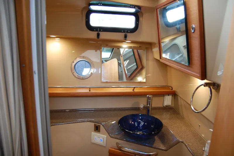  Yacht Photos Pics 2018 Ranger Tugs R29 bathroom with modern sink, mirror, and porthole window.