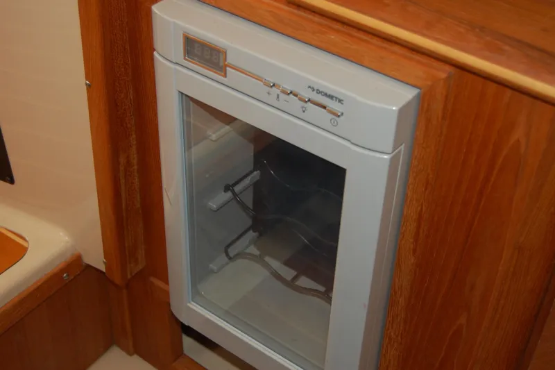  Yacht Photos Pics Dometic fridge inside 2018 Ranger Tugs R29 boat, featuring wooden cabinetry.