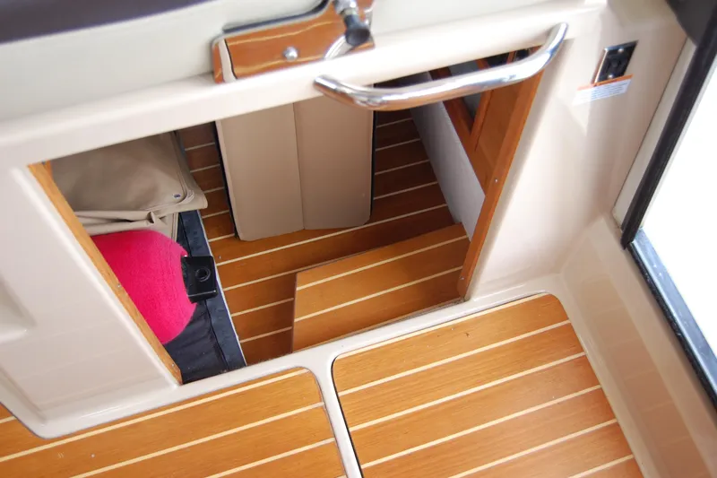  Yacht Photos Pics Interior view of 2018 Ranger Tugs R29 boat with wooden flooring and compact storage.