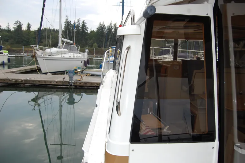  Yacht Photos Pics 2018 Ranger Tugs R29 docked at marina with sailboats in background.