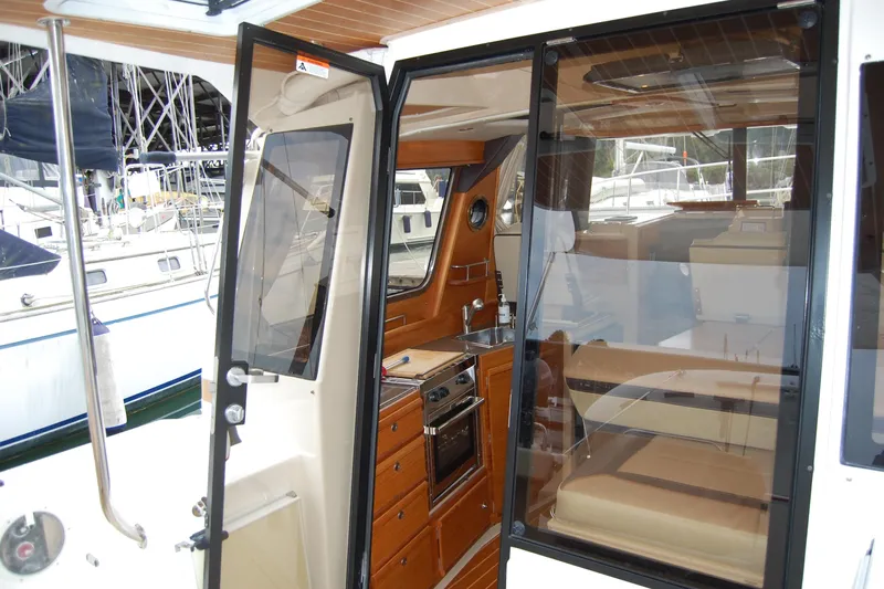  Yacht Photos Pics Interior view of 2018 Ranger Tugs R29, showcasing kitchen and seating area.