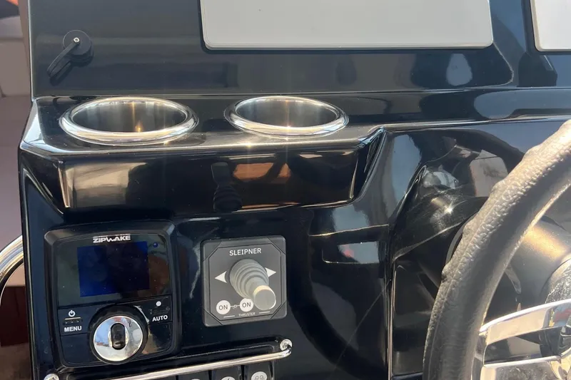  Yacht Photos Pics 2023 Jeanneau NC Weekender 1095 dashboard with controls and cup holders.