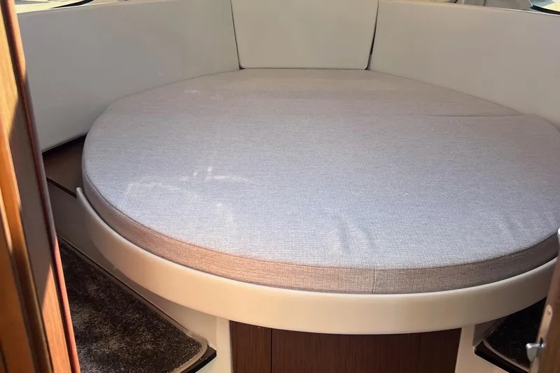  Yacht Photos Pics 2023 Jeanneau NC Weekender 1095 interior cabin with round bed.