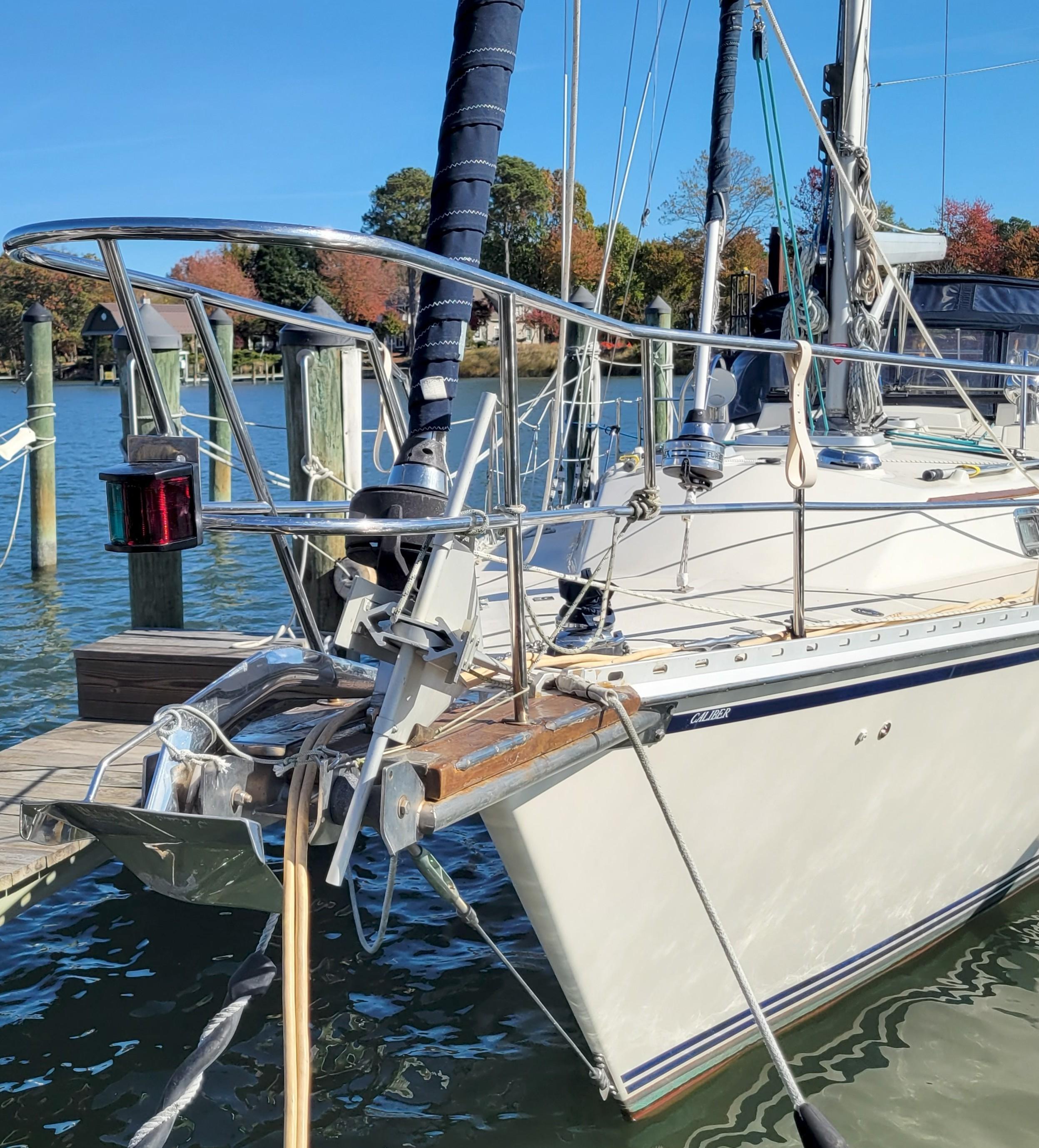 Sailboat Caliber 40 LRC SE 2003 docked at marina, clear blue sky.