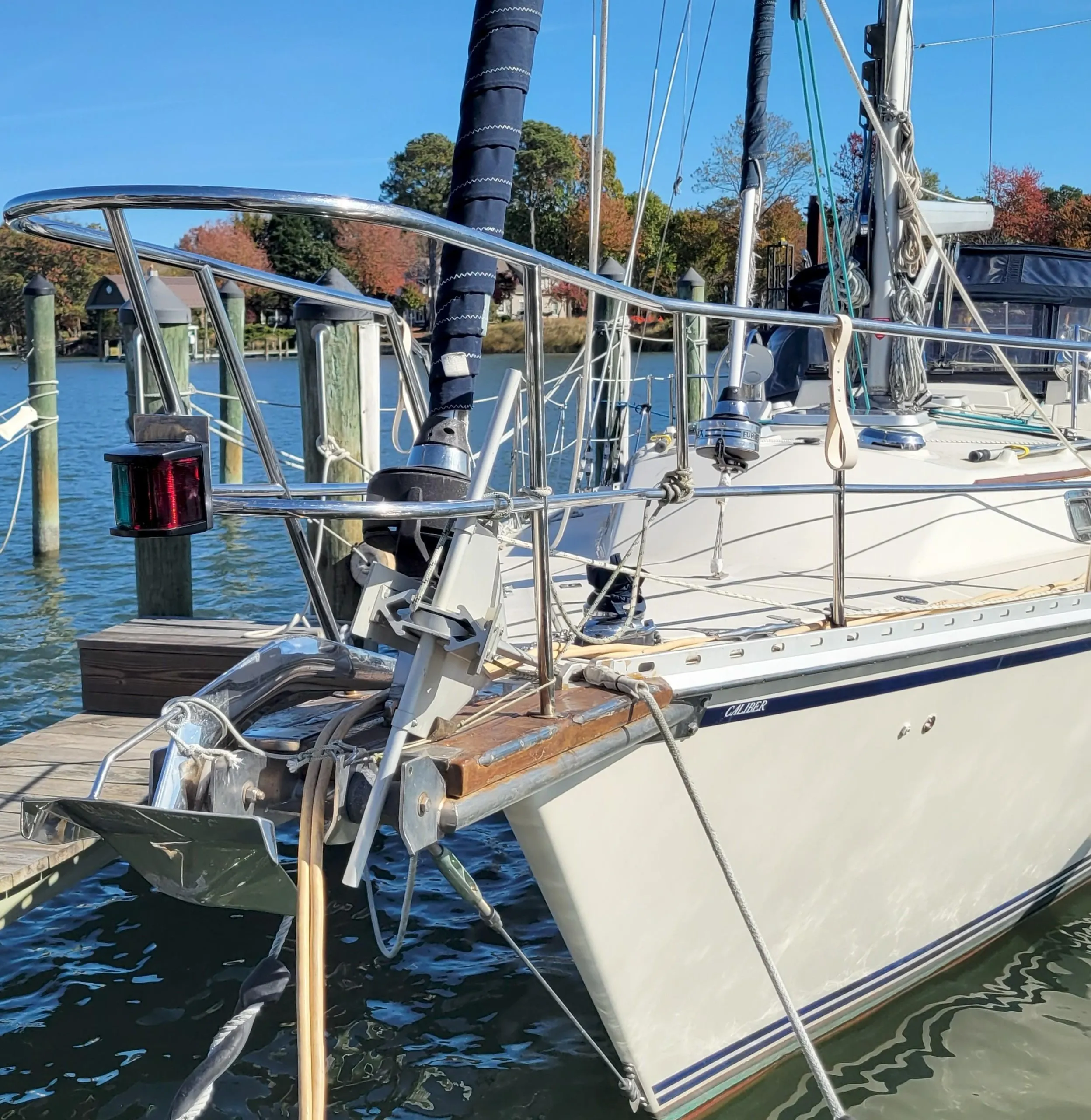 Sailboat Caliber 40 LRC SE 2003 docked at marina, clear blue sky.
